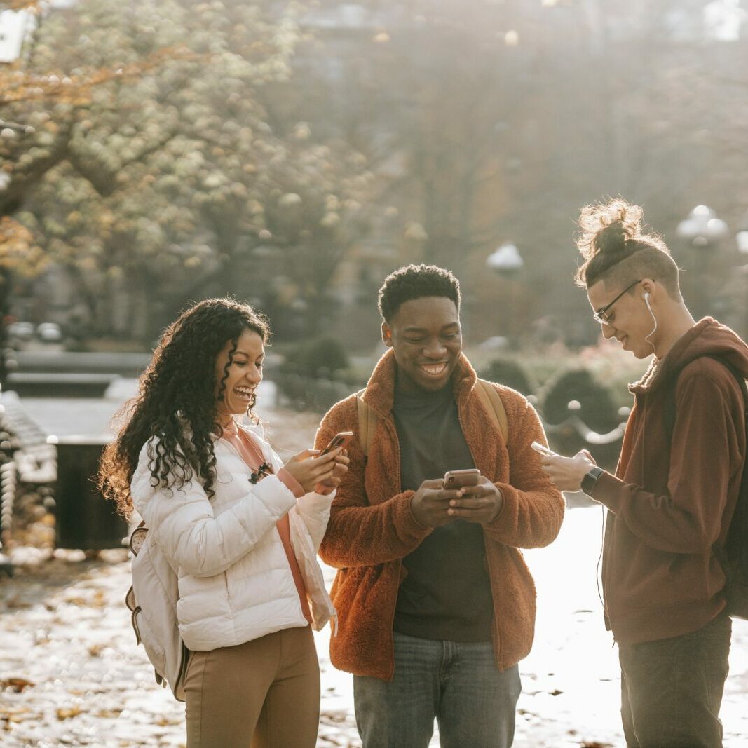 group of 3 people standing outside